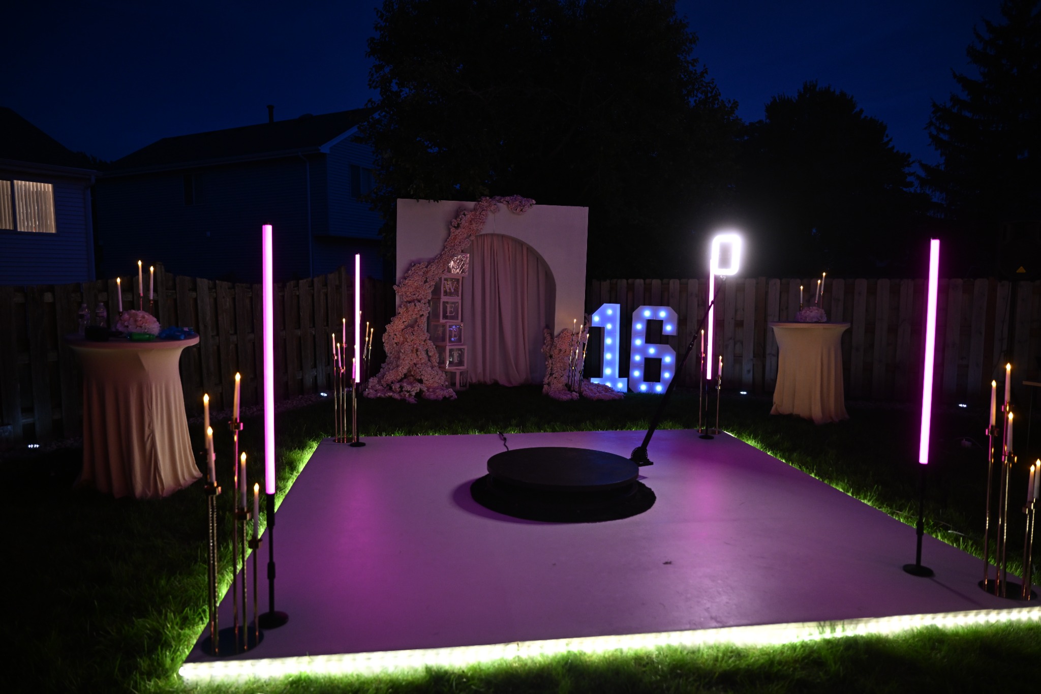 Guests on the AACT 360 booth platform beside its camera arm and event lighting